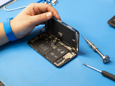Someone opening a cell phone to replace the battery