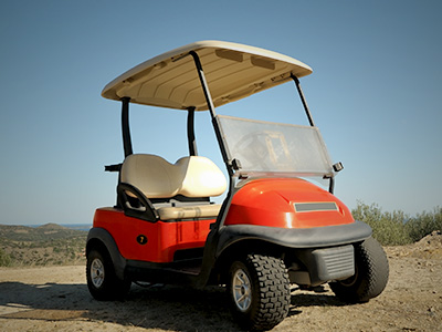 Golf cart on a dirt patch