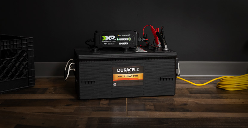 Fleet battery with an X2Power charger sitting on top charging it